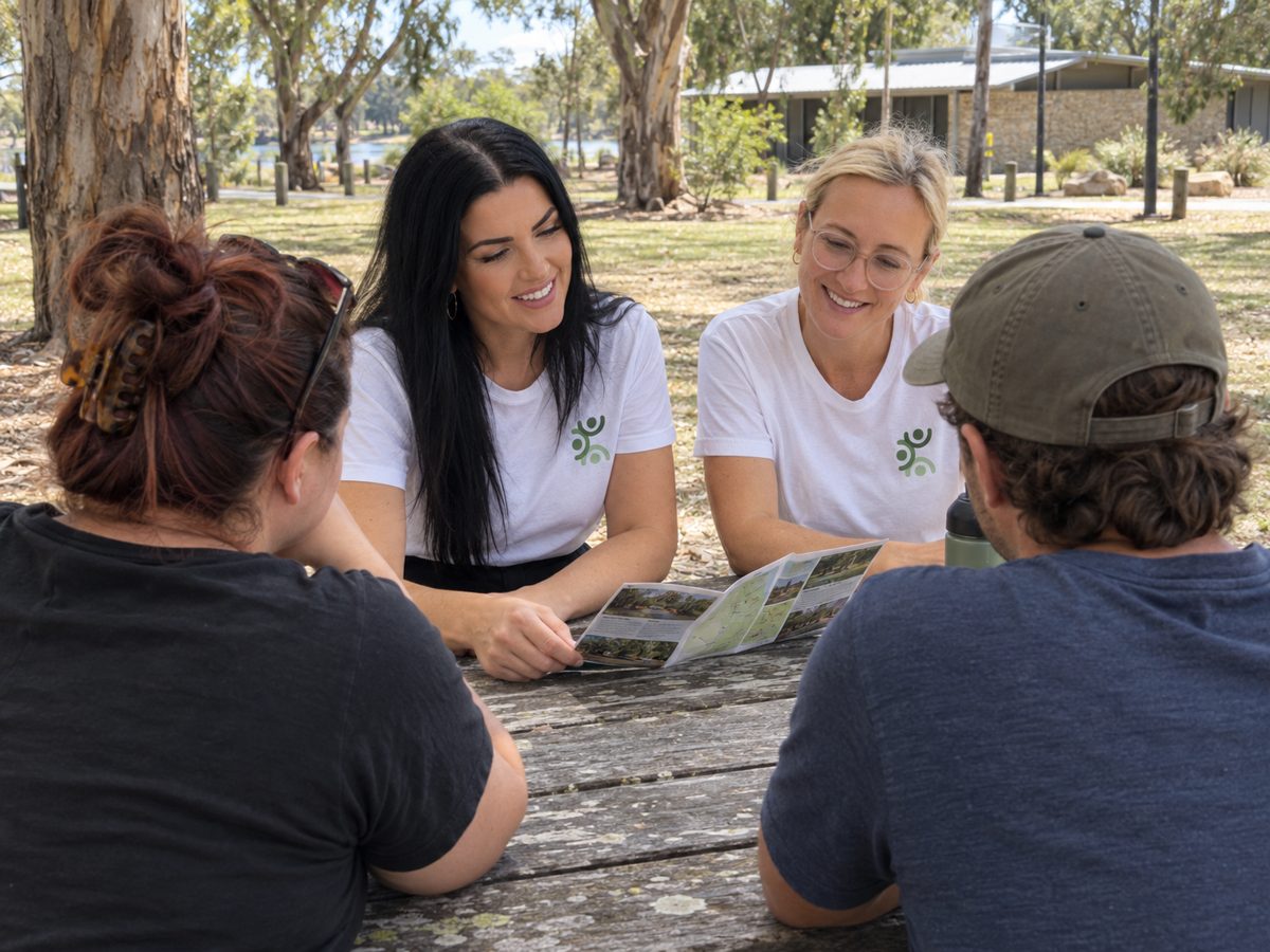 Mana practitioners sitting with a family at a park table